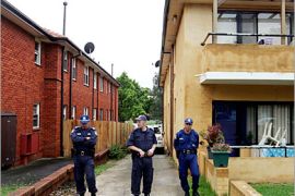 REUTERS/ Police stand outside one of the homes raided in southwestern Sydney as part of a series of counter-terrorism raids November 8, 2005. Australian authorities believe they