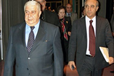 r - Syria's Deputy Foreign Minister Walid al-Moualem (L) and Riad al-Daoudi, legal advisor of the Syrian Foreign Ministry, arrive for a news conference in Damascus