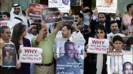 afp - Employees of the Qatari satellite channel al-Jazeera hold portraits of their colleagues Sami al-Haj (L), a Sudanese held in the US-run Guantanamo prison, and Taysser Alouni