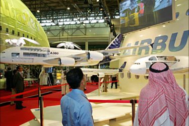 f_People visit the Airbus A380 stand at the Dubai Air show 21 November 2005. Boeing scored
