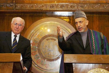 Afghan President Hamid Karzai (R) speaks during a press conference while Australian Prime Minister John Howard looks on at the Presidential palace in Kabul, 21 November 2005. Howard made his first visit to the country to see Australian troops, 151 of whom are stationed in southern Afghanistan as part of a US-led coalition. AFP PHOTO / SHAH Marai