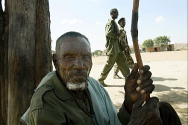 f_An Ethiopian war veteran sits in the shade 20 November 2005 while two young soldiers