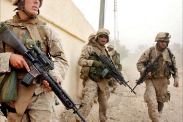 A picture released 20 November 2005 by the US Marines shows marines standing ready to advance 15 November 2005 during fighting in support of Operation Steel Curtain in the Iraqi town of Al Qaim, in al-Anbar province in western Iraq.