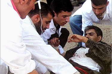 AFP / Iraqi doctors transfer a wounded civilian into a local hospital in the city of Tikrit, north of Baghdad, 10 November 2005. Five Iraqis were killed and 11 wounded when a car bomb