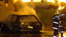 r_French firemen work as cars set alight by rioters burn in the La Reynerie neighbourhood of Toulouse November