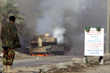 A US Abrams tank burns after being caught in a road side bomb 25 December 2005, along the highway in southeast Baghdad. Six people were killed in violence around the country. A car bomb killed two Iraqi civilians Sunday in the northern city of Kirkuk, while gunmen shot dead an interior ministry civil servant in Baghdad