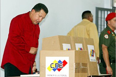 AFP - Venezuelan President Hugo Chavez casts his vote during the legislative elections 04 December, 2005 in Caracas. Venezuelans vote in legislative elections