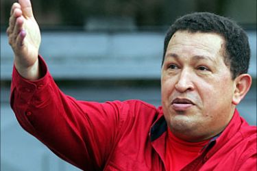 r_Venezuelan President Hugo Chavez greets supporters after casting his ballot during