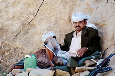 r_Armed Yemeni men rest in the northern Yemeni province of Marib, 180 km (99 miles) northeast from the
