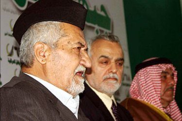 f_Adnan al-Dulaimi (L), one of the leaders of the National Concord Front, speaks during a press