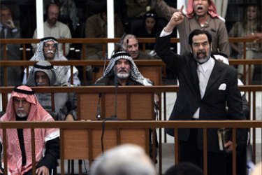 Former Iraqi President Saddam Hussein (front C) and Barzan Ibrahim al-Tikriti berates the court during their trial in Baghdad, 05 December, 2005. All of Hussein's defense team walked out of the courtroom in protest after the judge denied a motion to immediately delay proceedings
