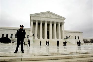 r_Police keep watch as "March For Life" protesters walk in front of the Supreme Court in Washington