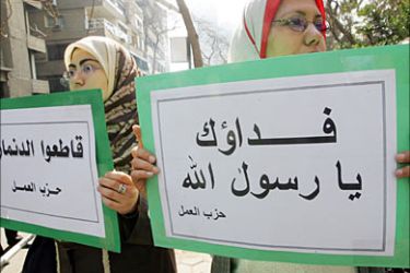f_Supporters of Egypt's Islamist Labour Party hold up signs reading in Arabic: "We would sacrifice our lives for you, Prophet Mohammed (R)," and "Boycott Denmark," during a protest outside the Danish embassy in Cairo, 20 February 2006. Muslim anger over the publication in Scandinavia of cartoons depicting the Prophet Mohammed has snowballed into a full-fledged crisis threatening Nordic trade and security. AFP PHOTO/KHALED DESOUKI