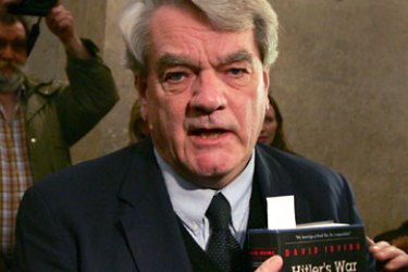 AUSTRIA : British historian David Irving appears in court in Vienna with handcuffs 20 February 2006 with his 1977 book "Hitler's War" in which he claimed the Nazi dictator Adolf Hitler did not know about the mass killings of Jews until 1943 and that he never ordered the Holocaust