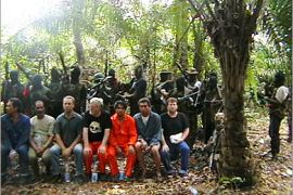 REUTERS/ An undated handout photo sent to Reuters on February 23, 2006 by kidnappers purportedly shows seven of the nine foreign oil workers kidnapped on Saturday by Nigerian