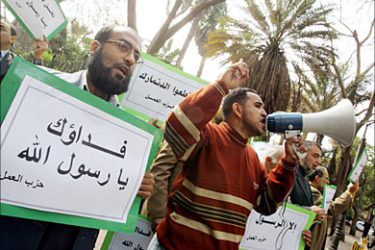 F_Members of Egypt's Islamist Labour Party hold up signs reading in Arabic: "We would sacrifice our