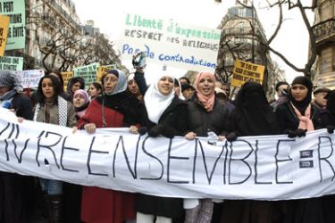 AFP: People hold a banner, reading : "Live together", 11 February 2006 place de la Republique in Paris, during a demonstration of Muslims to vent their anger over satirical images