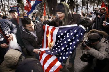 afp - Protesters burn an American flag outside the U.S. embassy in Stockholm, 18 March 2006, during a demonstration against the US-led invasion of Iraq in 2003