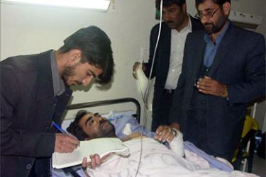 An Iranian journalist notes testimony 17 March 2006 from a man wounded by a group of armed bandits from neighboring Afghanistan in a hospital in Zabol town of southeastern province of Sistan-Baluchistan near the Afghan border, 16 March 2006.