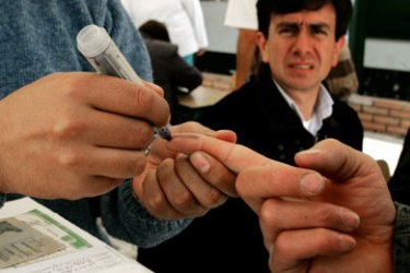 A Colombian is marked after he deposits his ballot in La Calera, Colombia, March 12, 2006.