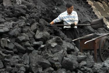 A Chinese collier works in a coal field in Nanjing, capital of China's Jiangsu province March 20, 2006. Some Chinese coal and power companies have agreed to a 5 percent rise in term coal prices,