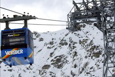 r_A Televerbier gondola rides up a mountain in the skiing area of the chic Swiss winter resort of Verbier