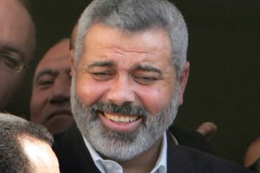 Hamas leader and Palestinian prime minister-designate Ismail Haniyeh walks among his supporters in Gaza March 11, 2006. Israel could target Haniyeh if the senior Hamas leader