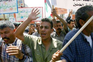 Palestinians protest against aid sanctions as they rally outside the United Nations offices in Gaza City, 30 April 2006. The Palestinian government is in dire financial straits after the United States and European Union slashed funds to the PA after the Islamic radical group Hamas swept legislative elections in January.