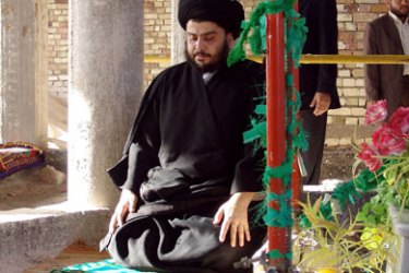 A picture released by the radical Shiite cleric Moqtada Sadr's Mehdi militia, 10 April 2006, shows Muqtada al-Sadr kneeling for prayer following a march by his supporters through the streets of the holy city of Najaf,