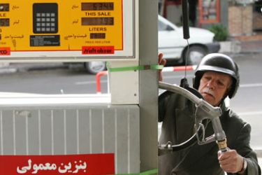 An Iranian motorcyclist takes the pumper to pump gasoline at a petrol station in downtown Tehran, 19 April 2006. Iran's President Mahmoud Ahmadinejad has called