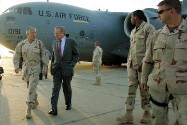US Defense Secretary Donal Rumsfeld (C) speaks with US Army General George Casey (2nd L) upon arriving at Baghgad International Airport 26 April 2006. Rumsfeld is in Baghdad to meet with US officials and in support of the new Iraqi government officials