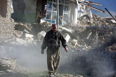 An Iranian man walks amid rubble of destroyed houses in Haydar Abad village 02 April 2006 near the city of Brujerd, following a powerful earthquake that struck western Iran two days before.