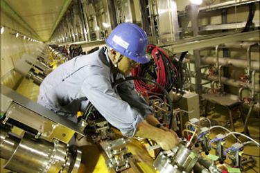 epa00714467 Japanese technicians work in along the 3.6km-long proton accelerator track 15m underground in the Drift Tube Linac facilities at the