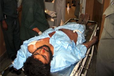 A wounded Afghan man is brought to a hospital after a U.S.-led air strike in Kandahar, Afghanistan May 22, 2006. Aircrafts from a U.S.-led force in Afghanistan attacked Taliban strongholds in the south of the country on Monday and may have killed up to 50 of the insurgents, a military spokesman said. Residents of the area said that up to 35 civilians were killed.