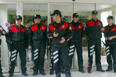 Police take security measures at the entrance of the court house in Ankara May 17, 2006. A gunman opened fire in Turkey's top administrative court on Wednesday injuring five