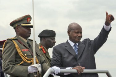 Recently re-elected President, Yoweri Kaguta Museveni, (R) gives party supporters the National Resistance Movement's (NRM) thumbs up symbol during his swearing-in ceremony