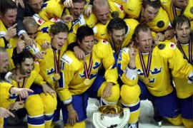 Sweden's players pose for a picture with a trophy after their team's victory over Czech Republic in the final match at the Ice Hockey World Championship in Riga May 21, 2006.