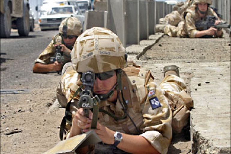 f_British soldiers secure the site where a military vehicle was destroyed in the southern city of Basra, 20 May 2006
