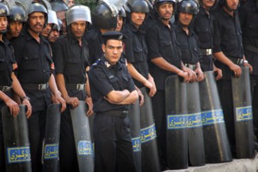 Egyptian riot policemen stand in line during a protest in Cairo May 3, 2006. About a hundred a protesters, vastly outnumbered by riot police,