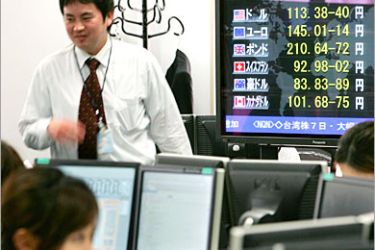 REUTERS/ Money traders work by a display showing the foreign exchange rates in a dealing room in Tokyo June 7, 2006. The dollar slipped against the yen but stayed near one-month