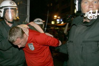 German riot police arrest an England soccer fan after violence broke out following the match Sweden against England during the World Cup soccer tournament in the centre of Cologne June 20, 2006.