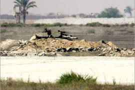 AFP - An Israeli tank (C) is entrenched near the run way at the Gaza International Airport in the southern Gaza Strip city of Rafah 29 June 2006. The European Union expressed deep concern about rising tensions between Israel and the