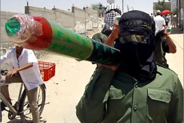AFP - A palestinian militant carries a locally made rocket in the southern Gaza Strip town of Rafah 18 June 2006. Palestinian activists consider these rockets an effective weapon against Israel because it failed so far to