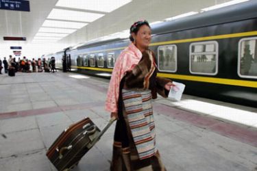 An ethnic Tibetan boards the first train at Lhasa Railway Station as it heads for Lanzhou in Gansu province July 1, 2006. China opened the world's highest railway