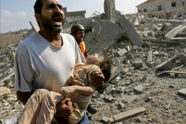 A man screams for help as he carries the body of a dead girl after Israeli air strikes on the southern Lebanese village of Qana 30 July 2006. At least 51 people were killed, many of them children, when Israeli war planes blitzed Qana, the deadliest single strike since the Jewish state unleashed its war on Hezbollah 19 days ago.