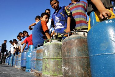 Palestinians line up at a domestic fuel station to fill cooking gas cylinders in the south of Gaza City, 02 July 2006, in the Gaza Strip. The United Nations warned that the Gaza Strip