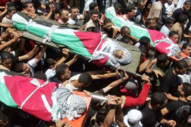 Palestinian mourners carry the bodies of three Al-aqsa brigades militants during their funeral in Balata refugee camp near the West Bank city of Nablus,July 20, 2006. Israeli