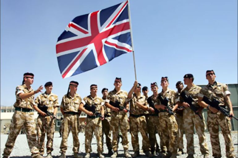 British soldiers from the NATO-led international peacekeeping force pose for a photo at the end of a military ceremony in Kabul August 6, 2006.