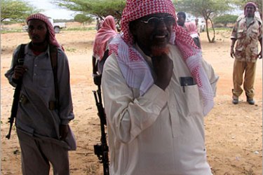 AFP - Sheik Hassan Dahir Aweys, the leader of the Islamic courts in Somalia gestures 22 August 2006 while observing the training of militias inside Hilweyne army barraks. Somalia's