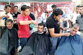 AFP / Palestinian hairdressers cut the hair of a local civil servants during a strike by the workers in Manger Square outside the Church of Nativity, the alleged birth place of Jesus Christ, in